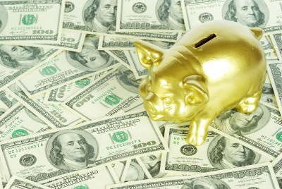 Gold piggy bank on dollars